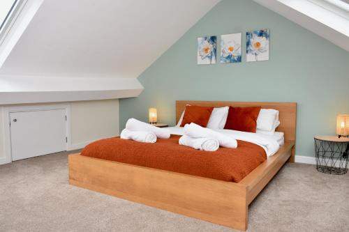 a bedroom with a large bed with towels on it at Cosy yet spacious, 3BR, Parking, Village Location in Oswestry