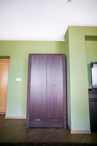 a wooden door in the corner of a room at Tulipan Hotel Aquapark in Vyshkove