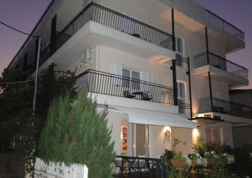 a large white apartment building with a balcony at Hanioti hotel in Hanioti