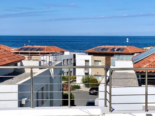 a view of the ocean from a balcony at Boho Bay Apartment in Akanthou