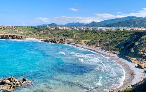 an aerial view of a beach with blue water at Boho Bay Apartment in Akanthou