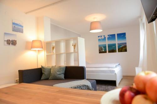 a living room with a couch and a bed at Ferienwohnung Malou in Tettnang