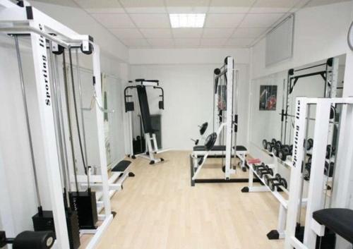 a gym with several tread machines in a room at Hanioti hotel in Hanioti