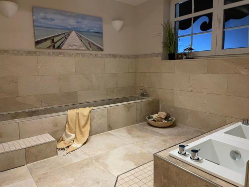 a large bathroom with a tub and a sink at Meer and Mehr in Zingst