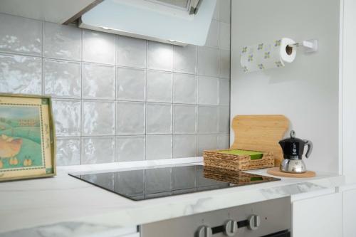 a kitchen with a counter top with a tea kettle at La Casetta - Gaslini e Boccadasse - private parking & garden in Genova