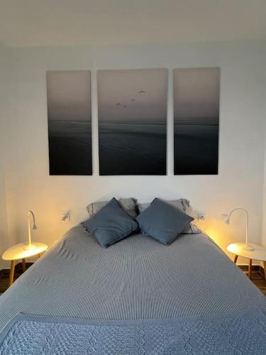 a bedroom with a large bed with two tables at Brisamar, serenidad frente al mar in Bajamar
