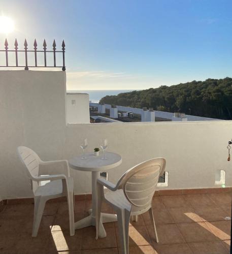 a table and chairs on a balcony with a view at Apartamento con vistas al mar in Conil de la Frontera