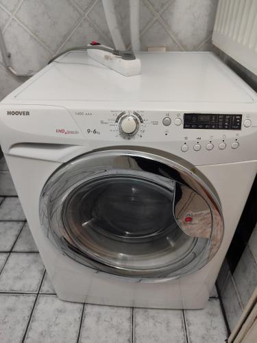 a white washing machine with its door open at Apartments to nature A in Ámmos
