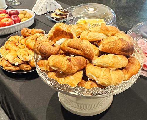 a plate of croissants and other pastries on a table at Castelar Hotel Santa Fe in Santa Fe