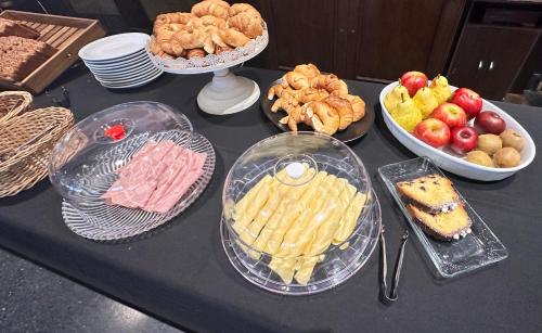 a table topped with plates of food and bowls of food at Castelar Hotel Santa Fe in Santa Fe