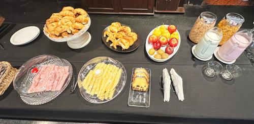 a table topped with different types of food and drinks at Castelar Hotel Santa Fe in Santa Fe