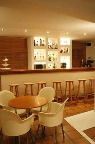 a bar with chairs and a table and a counter at Hanioti hotel in Hanioti