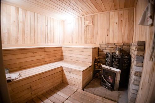 an empty wooden sauna with a fireplace in it at Stepsa Guest House in Lermontovo