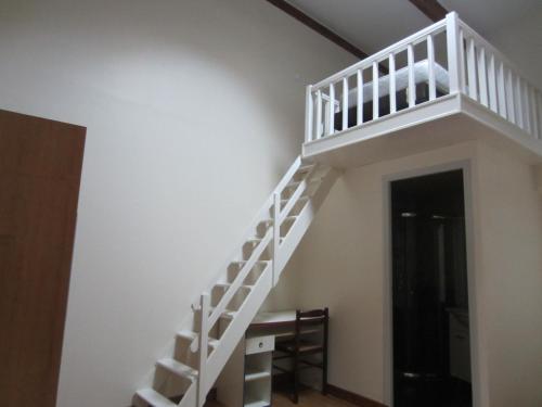 - un escalier blanc dans une chambre avec une porte dans l'établissement Belvedere, à Le Pré-Saint-Gervais