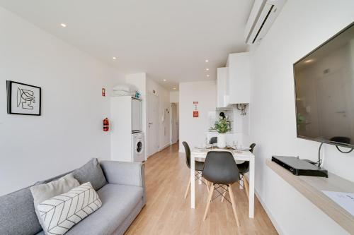 a living room with a couch and a table at By the Palace - Ajuda Apartments in Lisbon