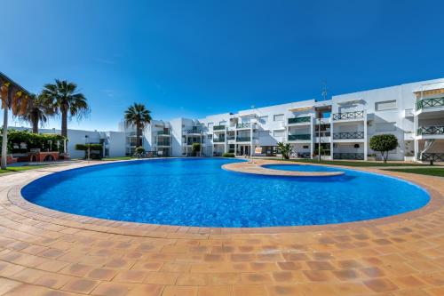 a large swimming pool in front of a building at Sun Lovers Altura T1 Pool & Balcony in Altura