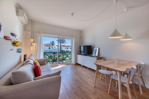 a living room with a couch and a table at Sun Lovers Altura T1 Pool & Balcony in Altura