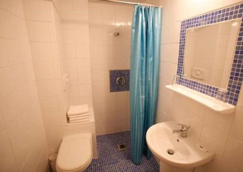 a bathroom with a toilet and a sink and a shower at Hanioti hotel in Hanioti
