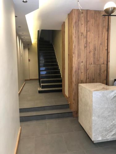 a hallway with stairs in a building with wooden walls at Besiktas KonukEvi hotel in Istanbul