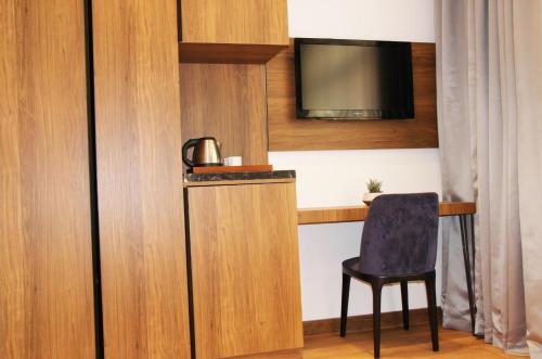 a room with a table and a chair and a television at Besiktas KonukEvi hotel in Istanbul