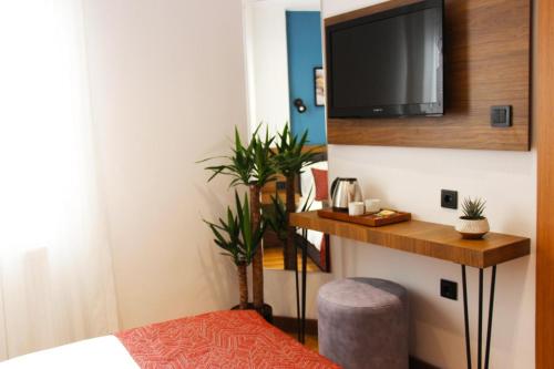 a bedroom with a tv on the wall and a bed at Besiktas KonukEvi hotel in Istanbul