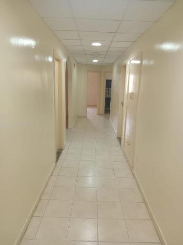 an empty hallway in an office building with ailed floor at FEMALE SHARING BED SPACE near CORNICHE in Sharjah