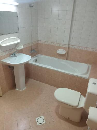 a bathroom with a tub and a toilet and a sink at SHARING BED SPACE FOR MALE near DUBAI BUS STOP in Sharjah