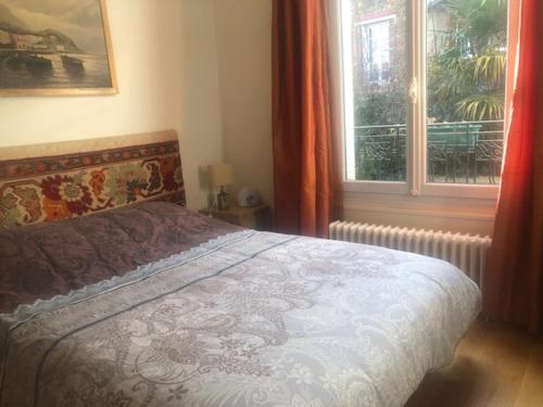 a bedroom with a bed and a window at Big house with terrace in Paris in Paris