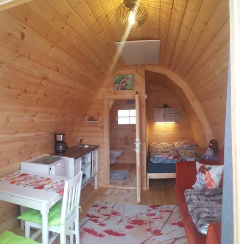 a log cabin with a kitchen and a living room at Tiny House Cuxhaven am See in Nordholz
