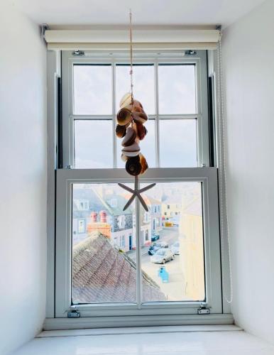 a christmas ornament hanging from a window at The Crows Nest in Eyemouth
