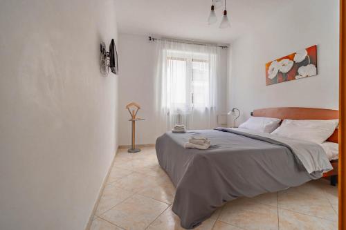 a bedroom with a bed and a window at Casetta : Polignano in Polignano a Mare