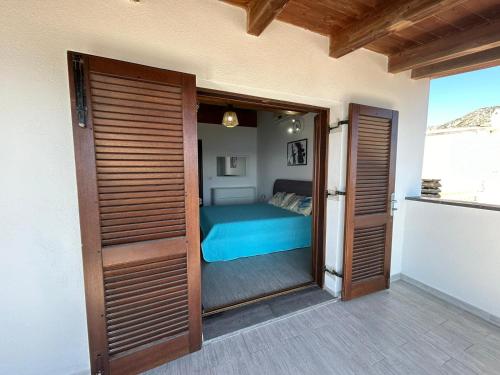 a bedroom with a bed through a sliding glass door at DOLCE VITA holiday home in Cala Gonone