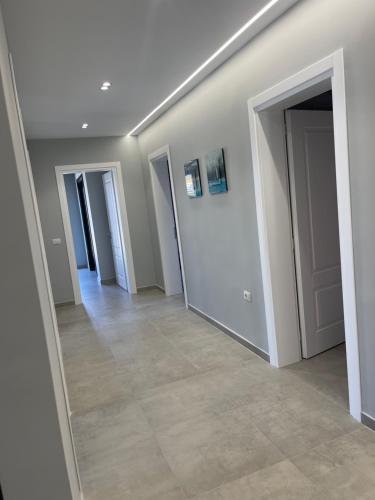 a hallway with white walls and a tile floor at Luxury Rooftop Vlora in Vlorë
