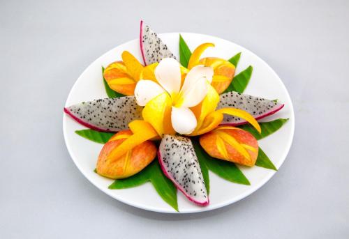 a plate of flowers on a white plate at Vacation Boutique Hotel in Phnom Penh