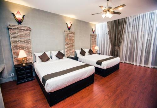 um quarto com 2 camas e uma ventoinha de tecto em Vacation Boutique Hotel em Phnom Penh