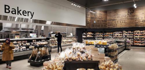 a person standing in a grocery store aisle with a bakery at Scarborough New 2-Bedroom Basement in Toronto