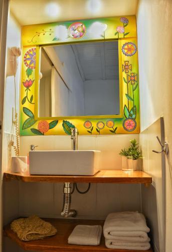a bathroom with a sink and a mirror at Posada Santa Rita in Colonia del Sacramento