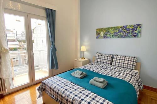 una camera da letto con un letto e due asciugamani di Glorious Mediterranean 顶层海景公寓 ad Atene