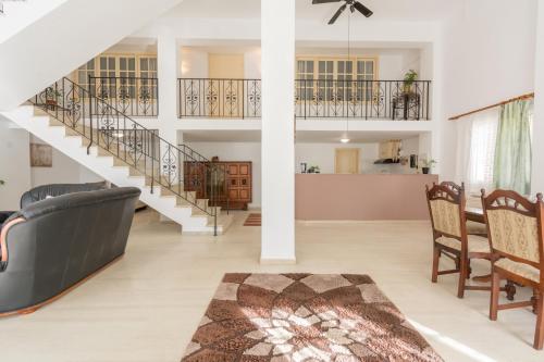 a living room with a staircase and a dining room at Sunshine House in Episkopianá