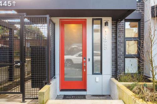 a red door on the side of a house at 2BR 2BA Capitol Hill Cozy Haven- Rooftop in Seattle