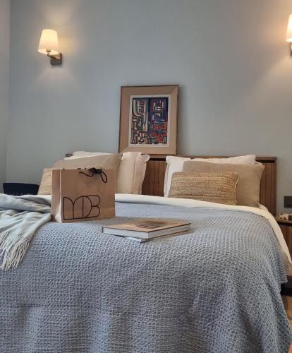 a bedroom with a bed with a book on it at Maison Lùisa in Autun