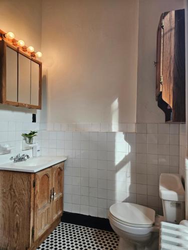 a bathroom with a toilet and a sink at Entire floor in a charming townhouse in New York