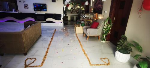 a living room with hearts spelled out on the floor at منتجع سمايل in Al Qurayyat