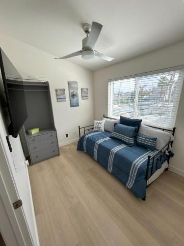 a bedroom with a bed and a flat screen tv at Oceanside Getaway in Oceanside