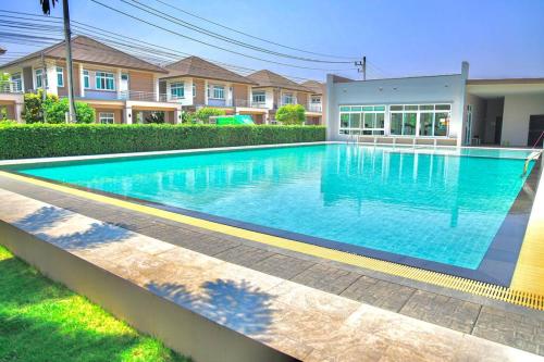 a swimming pool in front of a house at Luxury Entire House short term rent In Buriram City for SongKran Festival in Buriram