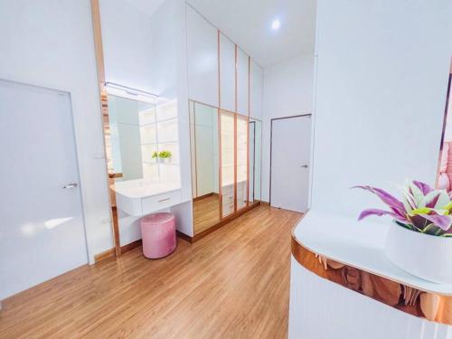 a bathroom with a white counter and a pink stool at Luxury Entire House short term rent In Buriram City for SongKran Festival in Buriram