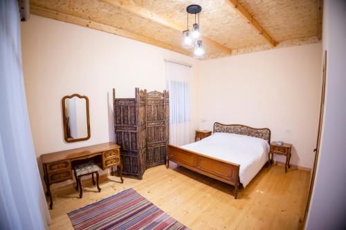 a bedroom with a bed and a dresser and a mirror at Stepsa Guest House in Lermontovo