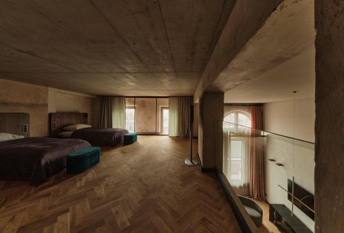 a bedroom with two beds and a wooden floor at Grand Hotel in Łódź