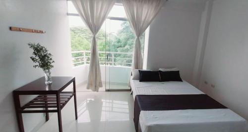 1 dormitorio con 2 camas y ventana en Hotel Loma Hermosa en Piura