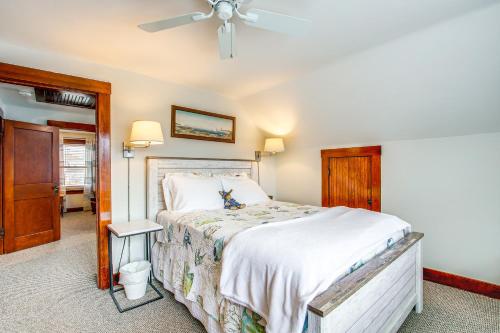 a bedroom with a bed and a ceiling fan at Anias Retreat with Deck Walk to Lake Michigan! in Two Rivers